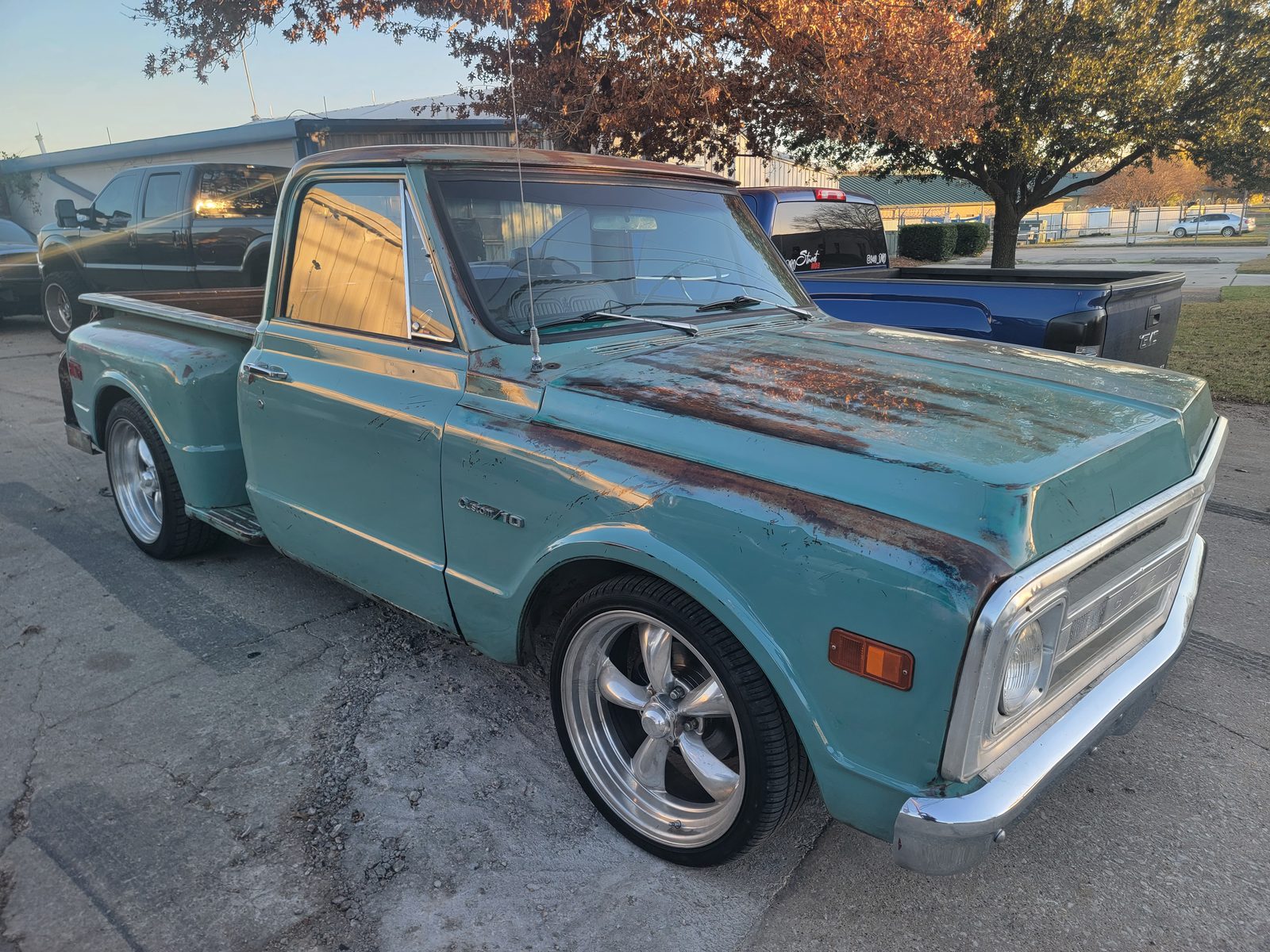 A teal classic Chevrolet C10 pickup with a weathered patina finish and polished wheels